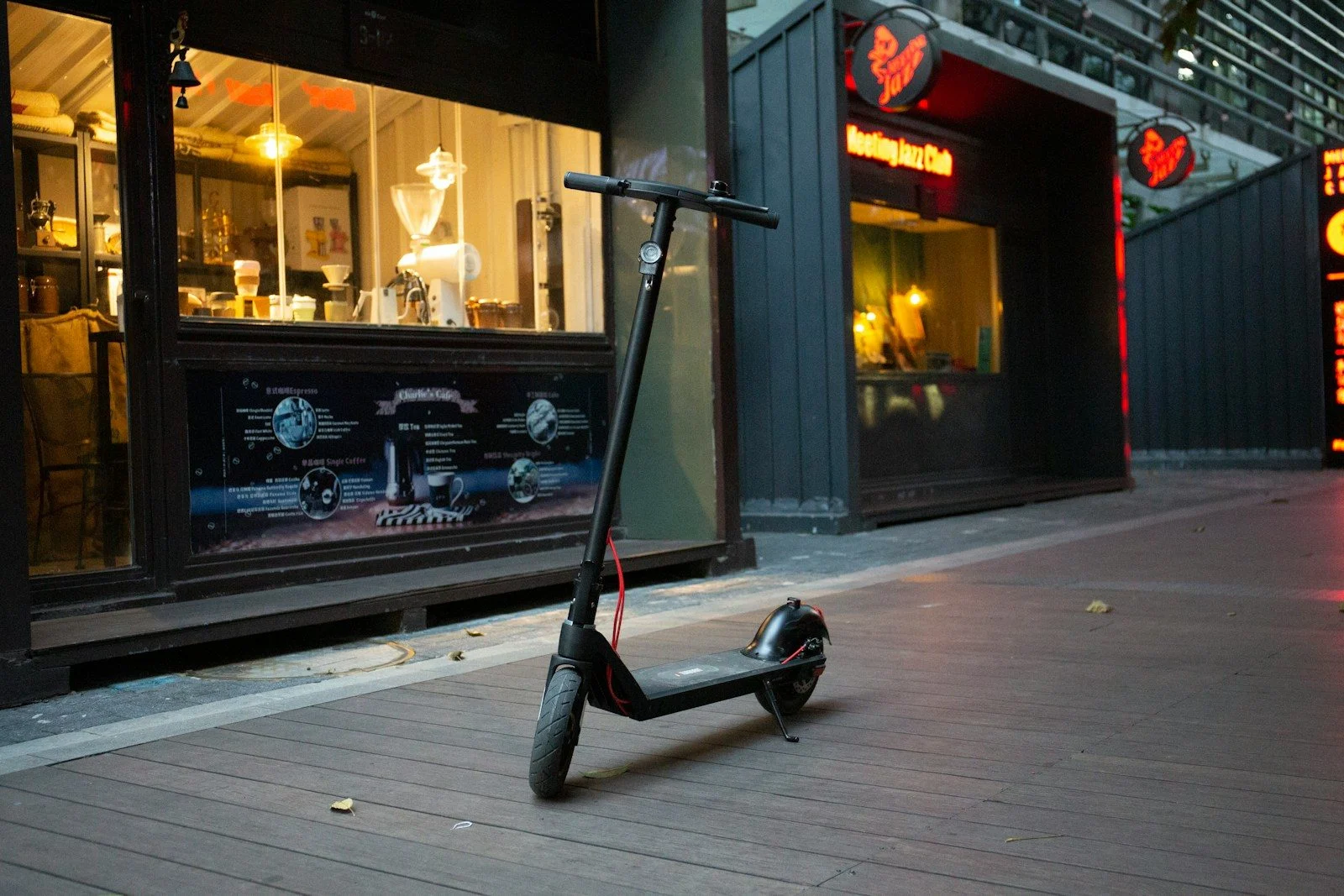 a scooter parked on the sidewalk in front of a store